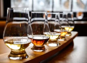 Enjoy the best spirits at Driftless Glen Distillery. A tasting of whiskey in glasses.