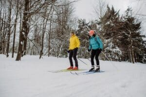 Cross-country skiing is one of many things to do at Devils Lake State Park in winter, just like this couple skiing through the forest.
