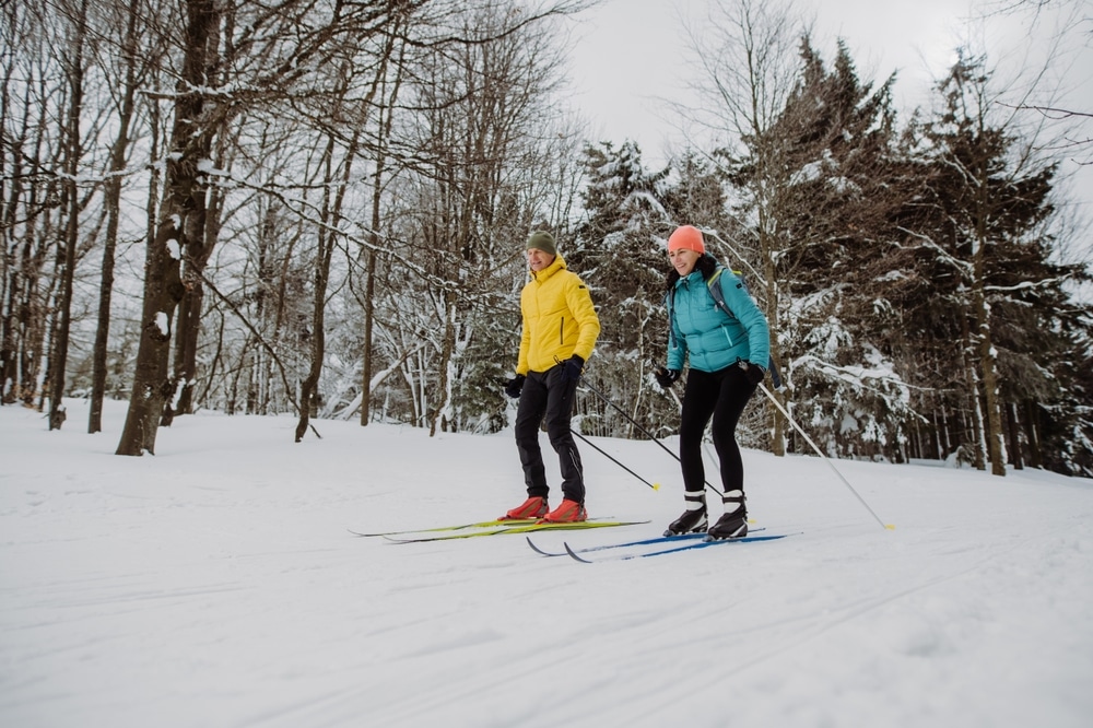 Cross-country skiing is one of many things to do at Devils Lake State Park in winter, just like this couple skiing through the forest.